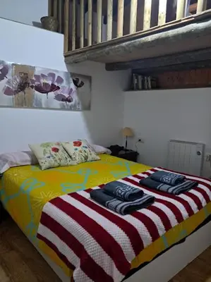 a bedroom with a bed with towels on it at La Casa de las Rocas - En la Ribeira Sacra in Nogueira de Ramuin