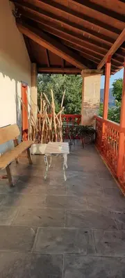 a pavilion with benches and tables on a patio at Rectoral de Anllo in Sober
