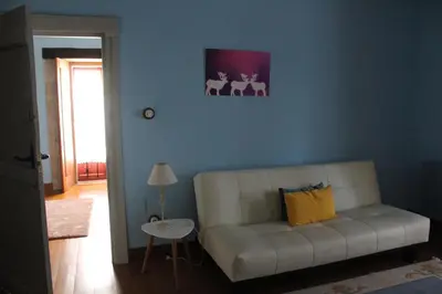 a living room with a white couch and a blue wall at Rectoral de Anllo in Sober