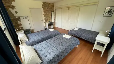 a room with two beds and a table at Twin Pines Camino Norte in Arzúa