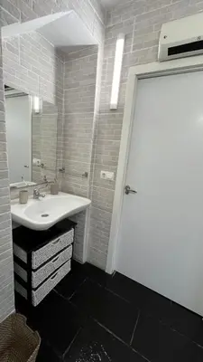 a bathroom with a white door and a sink at Twin Pines Camino Norte in Arzúa