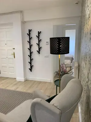 a living room with a chair and a lamp at Apartamento Barrio San Pedro in Santiago de Compostela