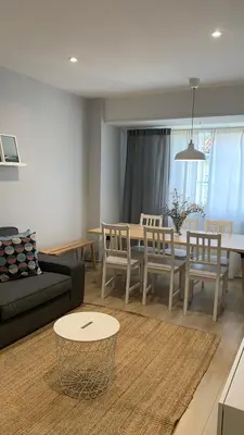 a living room with a couch and a table and chairs at Apartamento Barrio San Pedro in Santiago de Compostela