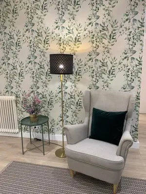a living room with a chair and a lamp at Apartamento Barrio San Pedro in Santiago de Compostela