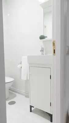 a white bathroom with a sink and a toilet at Apartamento Barrio San Pedro in Santiago de Compostela