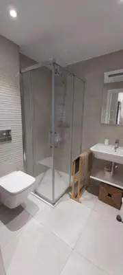a bathroom with a shower and a toilet and a sink at PortoHouse in Portomarin