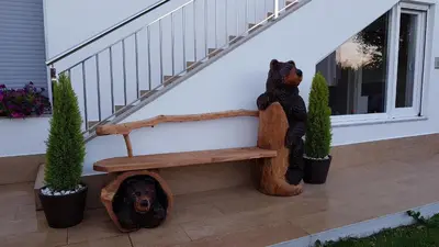 two teddy bears sitting on a bench on a porch at PortoHouse in Portomarin