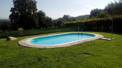 a swimming pool in the middle of a yard at Casa Rural Anxeliña in Boborás