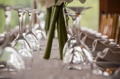 a row of wine glasses with flowers in them at Casa Rural Anxeliña in Boborás