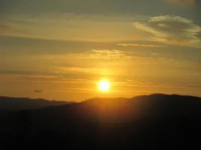 a sunset on the top of a mountain at Hotel Chola in Dorna