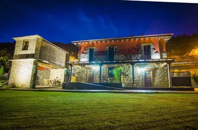 a house with a lawn in front of it at night at Alborada del Eo in Vegadeo