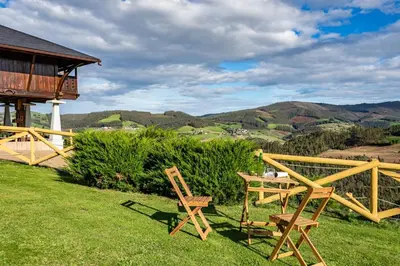 a couple of chairs and a table on a lawn at Alborada del Eo in Vegadeo