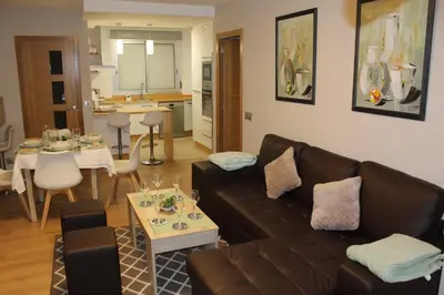 a living room with a brown couch and a table at Rosalía de Castro, 41 - Centro - VUT-CO-01904 in Santiago de Compostela