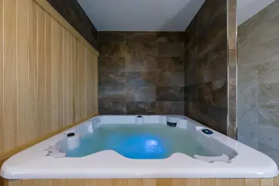 a large bath tub in a bathroom with at Hotel A Curuxa Wellness in Arzúa