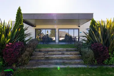 a house with stairs leading to the front entrance at Hotel A Curuxa Wellness in Arzúa