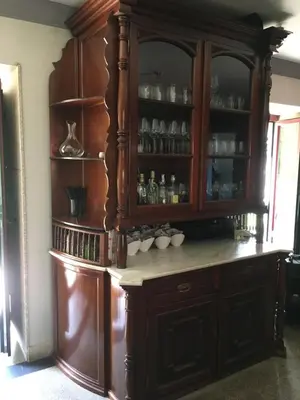 a large wooden hutch with cups in it at Casa das Veigas in Santa Eulalia