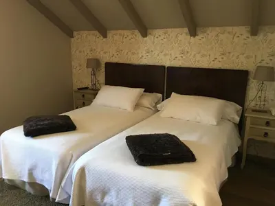 two beds sitting next to each other in a bedroom at Casa das Veigas in Santa Eulalia