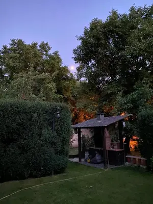 a gazebo in a yard next to a hedge at Pereje Garden in Pereje