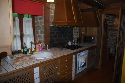 a kitchen counter with a sink and a stove at Pereje Garden in Pereje