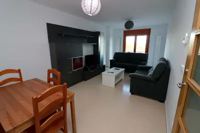 a living room with a couch and a table at Hostal CASASNOVAS in Silleda