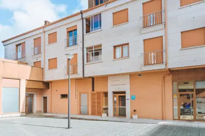 a building with a street light in front of it at Hostal CASASNOVAS in Silleda