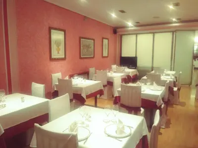 a dining room with white tables and white chairs at Hotel orly in Xinzo de Limia