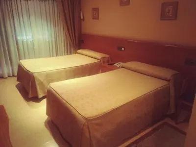 a room with two beds in a hotel room at Hotel orly in Xinzo de Limia