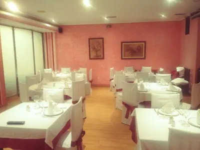 a dining room with white tables and white chairs at Hotel orly in Xinzo de Limia