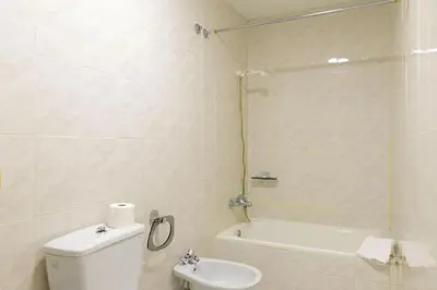 a bathroom with a toilet and a shower and a sink at Hotel Alda Xinzo in Xinzo de Limia