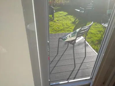 a door open to a patio with a chair on a porch at Casa Raposeira in Ourense