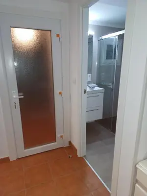 a bathroom with a shower and a glass door at Casa Raposeira in Ourense