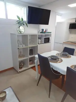 a dining room with a white table and chairs at Casa Raposeira in Ourense