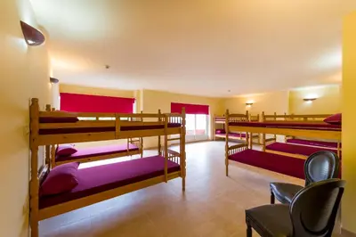 a group of bunk beds in a room at Albergue Vía Láctea in Arzúa