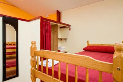 a bedroom with a bunk bed and a mirror at Albergue Vía Láctea in Arzúa