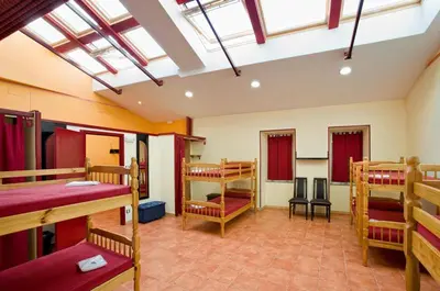 a room with several bunk beds in a room at Albergue Vía Láctea in Arzúa