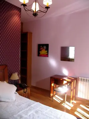 a bedroom with a bed and a desk in a room at Hotel Casa de Caldelas in Castro Caldelas