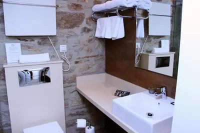 a bathroom with a sink and a mirror at Hotel Montenegro Compostela in Santiago de Compostela