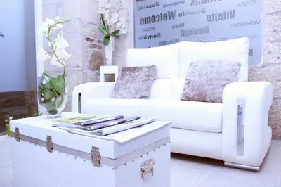 a living room with a white couch and a coffee table at Hotel Montenegro Compostela in Santiago de Compostela