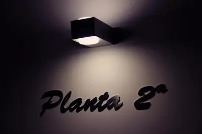 a light on a wall with the words planilla at Hotel Montenegro Compostela in Santiago de Compostela
