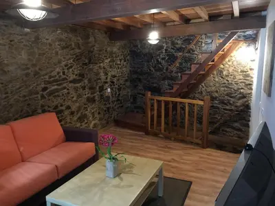 a living room with a couch and a table at Bonita Casa en Pontedeume in Puentedeume