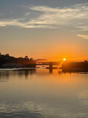 a bridge over a river with the sunset in the background at Bonita Casa en Pontedeume in Puentedeume