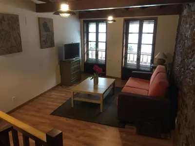 a living room with a red couch and a coffee table at Bonita Casa en Pontedeume in Puentedeume