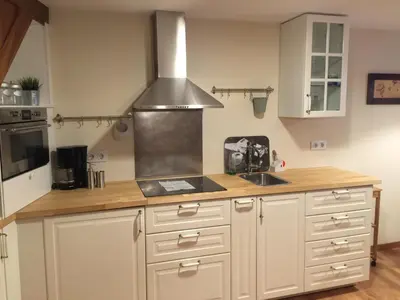 a kitchen with a sink and a stove top oven at Bonita Casa en Pontedeume in Puentedeume