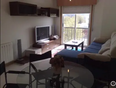a living room with a couch and a glass table at A Coruña al lado de la playa in Bastiagueiro