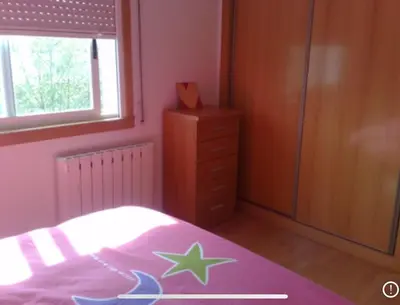 a bedroom with a bed and a dresser at A Coruña al lado de la playa in Bastiagueiro