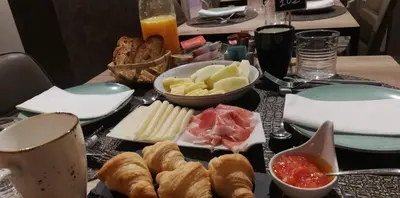 a table topped with plates and bowls of food at Hotel Roquiño in Caldas de Reis