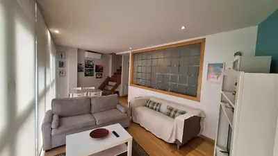 a living room with a couch and a table at Dúplex Plaza Saco y Arce in Ourense