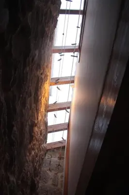 a window in a room with a stone wall at Casa Manuela in Allariz