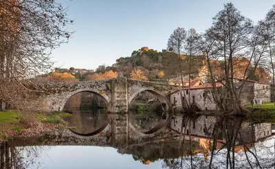 a stone bridge over a body of water at Casa Manuela in Allariz
