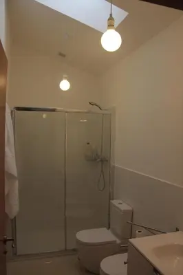 a bathroom with a shower with a toilet and a sink at Casa Manuela in Allariz